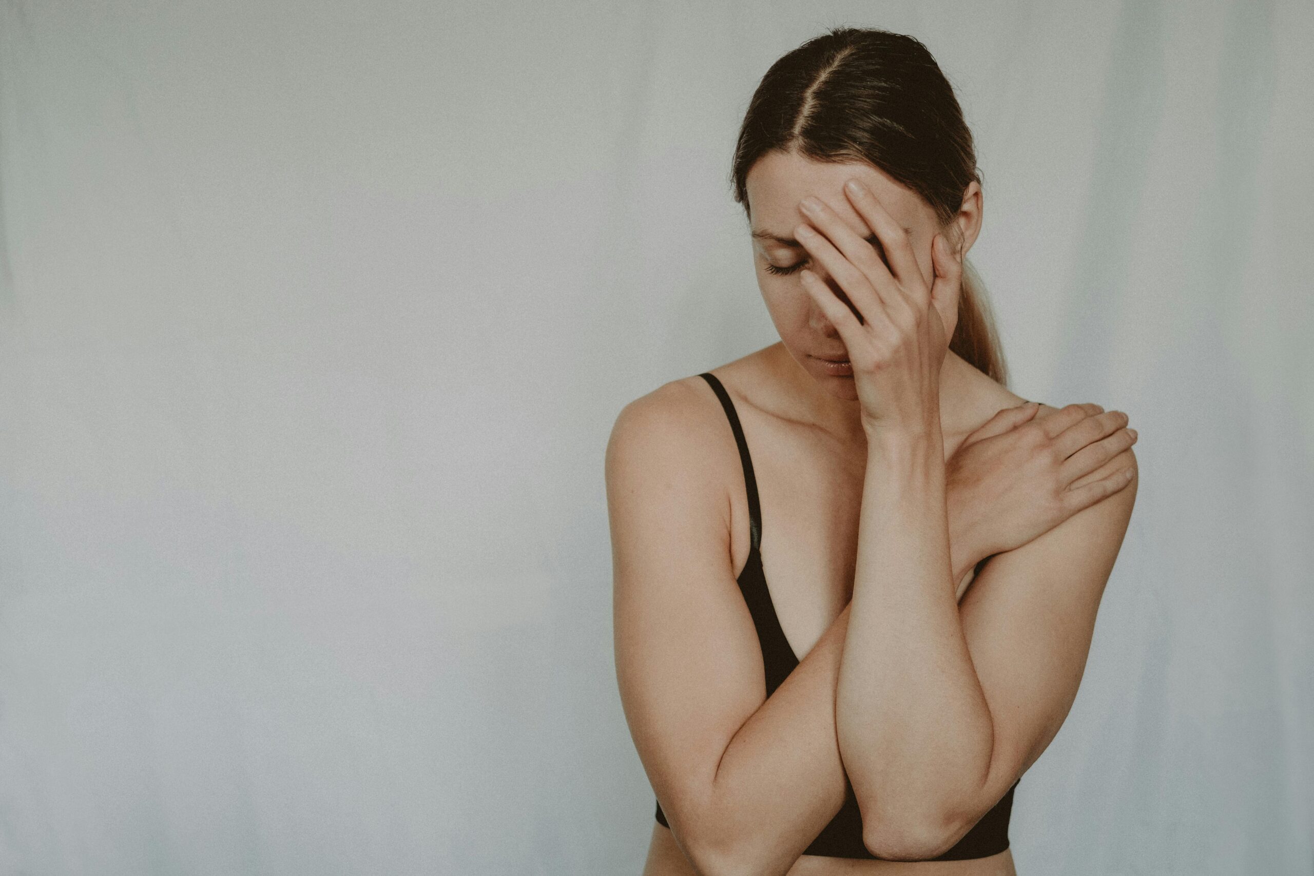 Young sad woman with closed eyes